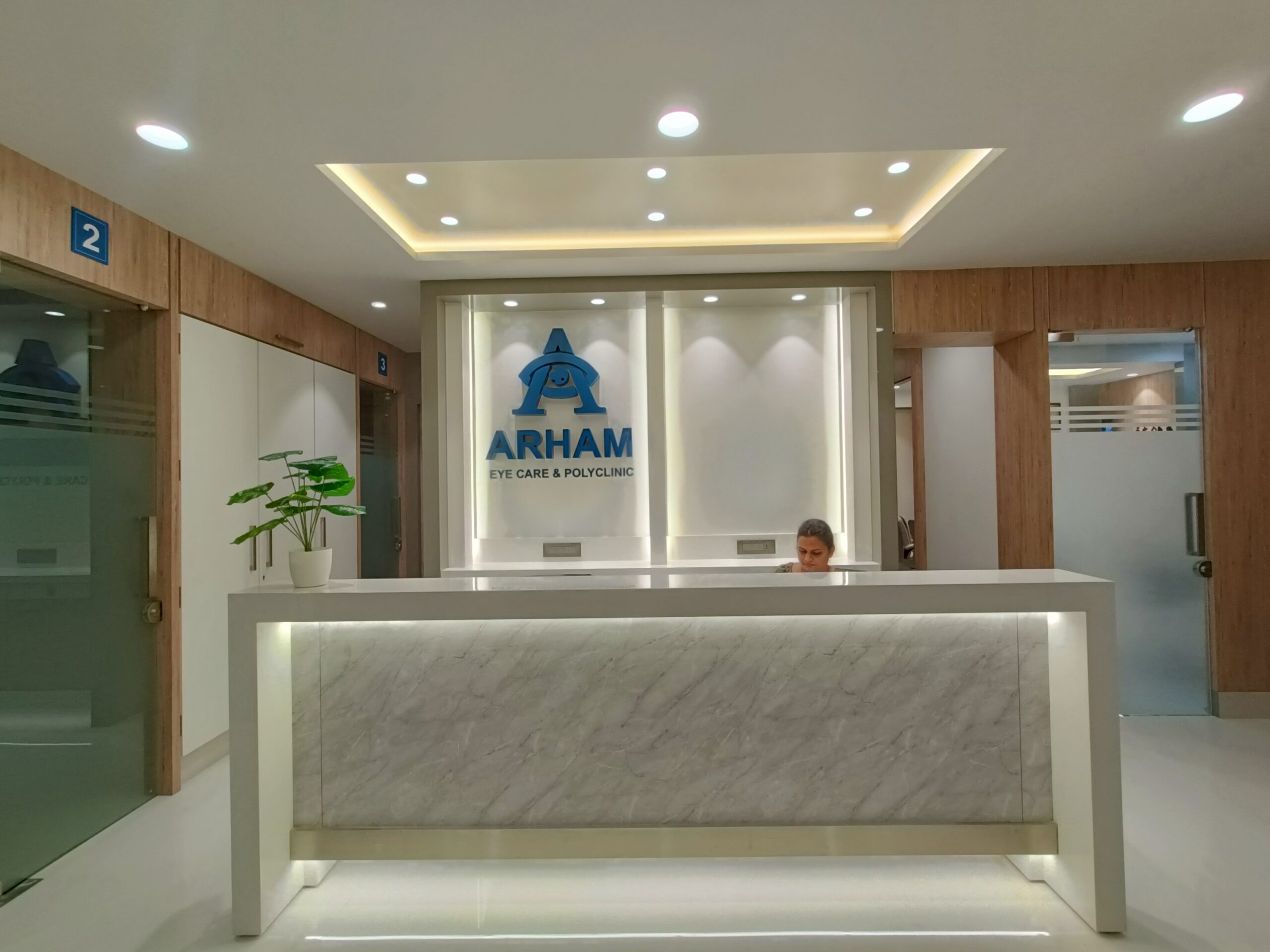 Arham Eye Care reception with branded back-wall